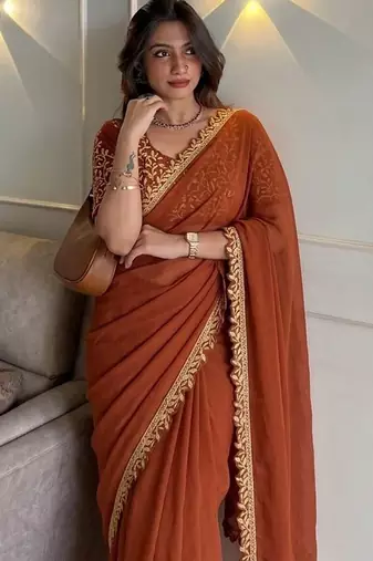 Appetizing orange embroidery cutwork work lace border rangoly silk party wear saree