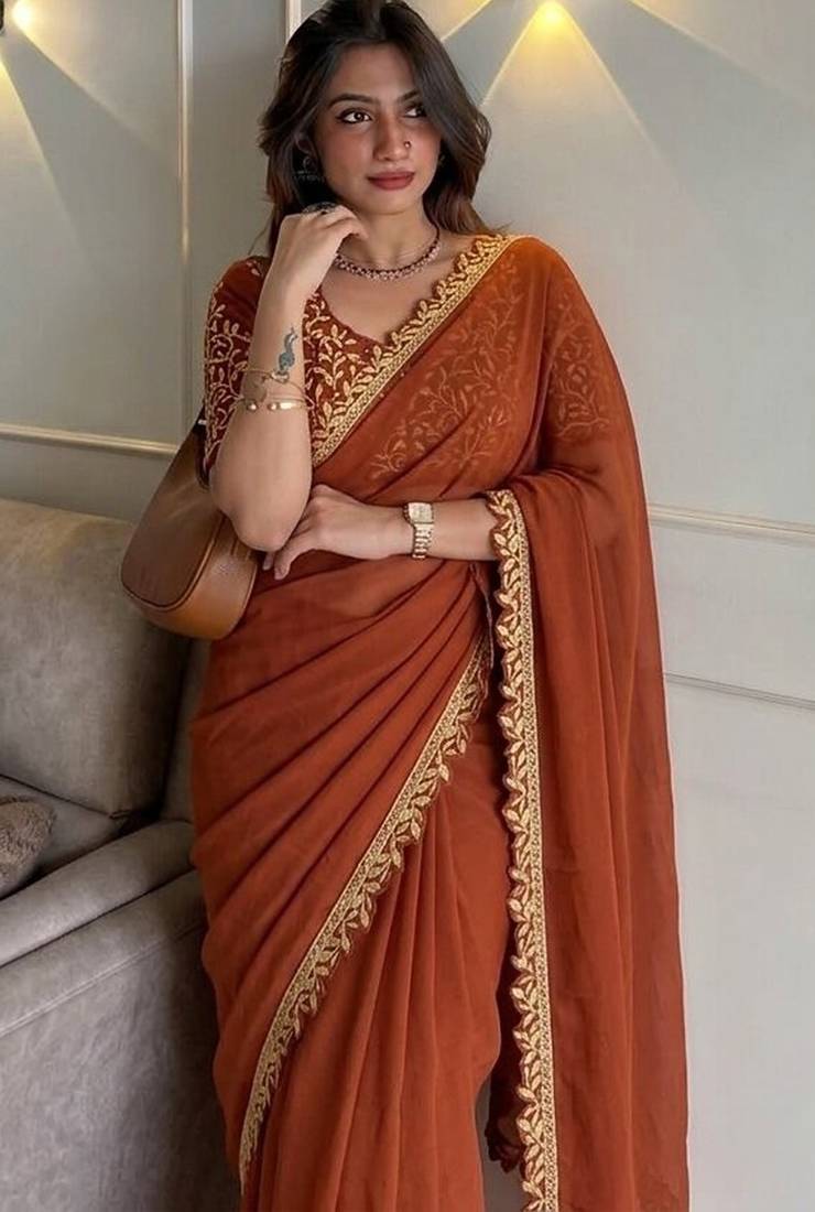 Appetizing orange embroidery cutwork work lace border rangoly silk party wear saree