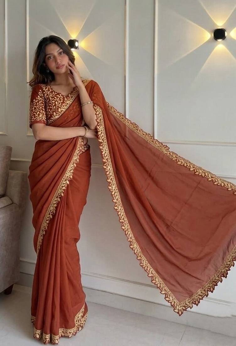Appetizing orange embroidery cutwork work lace border rangoly silk party wear saree