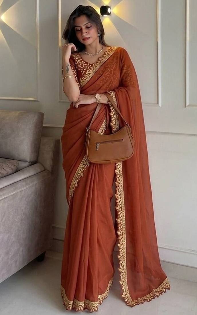 Appetizing orange embroidery cutwork work lace border rangoly silk party wear saree
