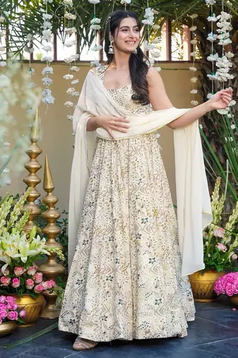 Off white color smart and stylish partywear rayon fabric gown with dupatta