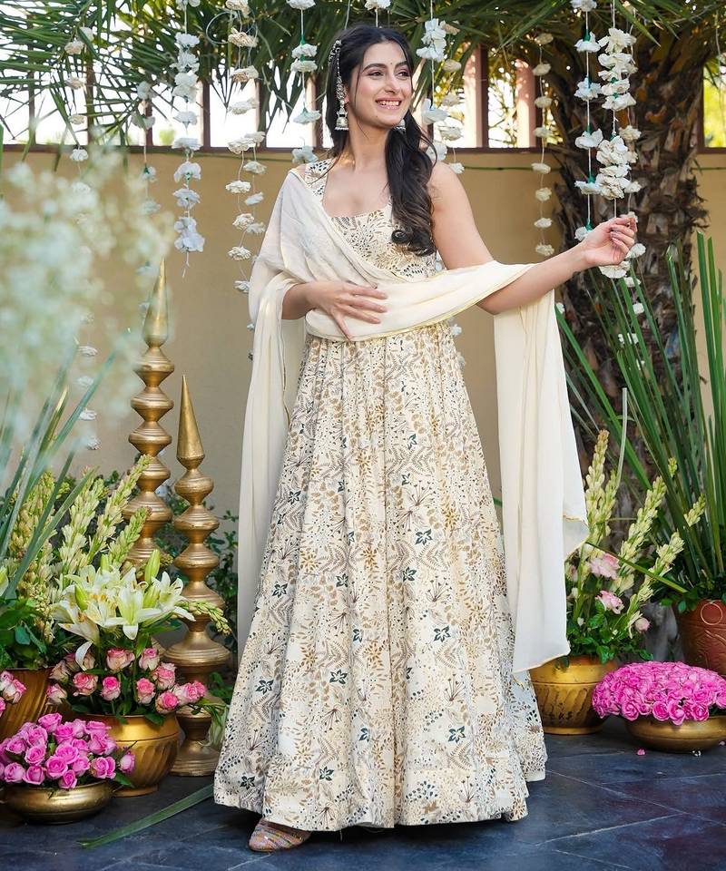 Off white color smart and stylish partywear rayon fabric gown with dupatta