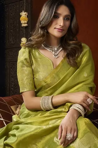 Olive heavy tissue with allover cow butta & fancy tassels saree