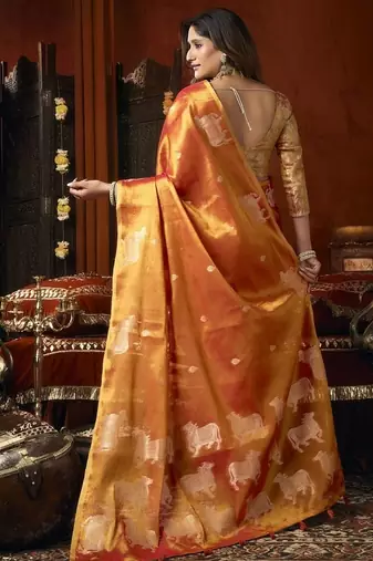 Orange green heavy tissue with allover cow butta & fancy tassels saree