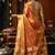 Orange green heavy tissue with allover cow butta & fancy tassels saree