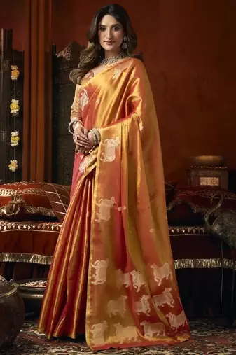 Orange green heavy tissue with allover cow butta & fancy tassels saree