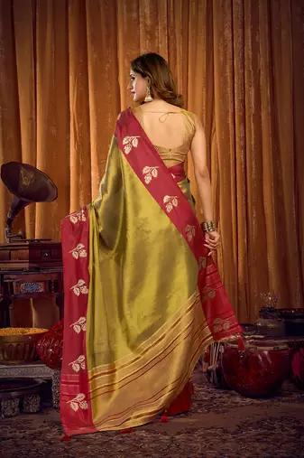 Olive green soft tissue silk blend saree with rani pink zari woven border