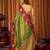 Green soft tissue silk blend saree with wine red zari woven border