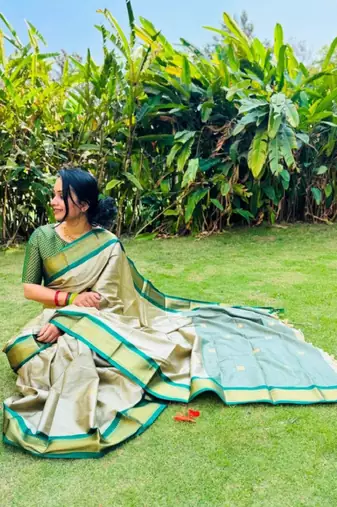 cream kanjeevaram saree with woven zari design
