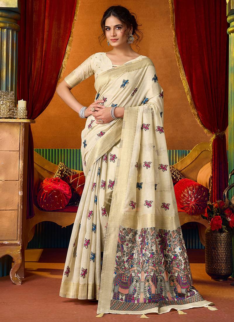 Cream cotton blend saree with traditional ethnic motifs and includes blouse piece