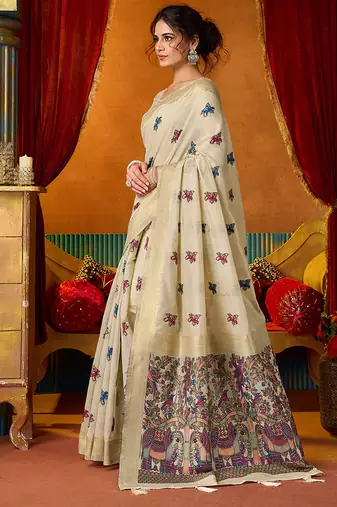 Cream cotton blend saree with traditional ethnic motifs and includes blouse piece