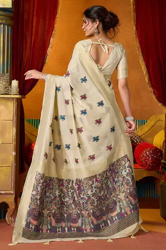 Cream cotton blend saree with traditional ethnic motifs and includes blouse piece