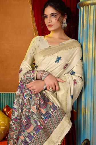 Cream cotton blend saree with traditional ethnic motifs and includes blouse piece
