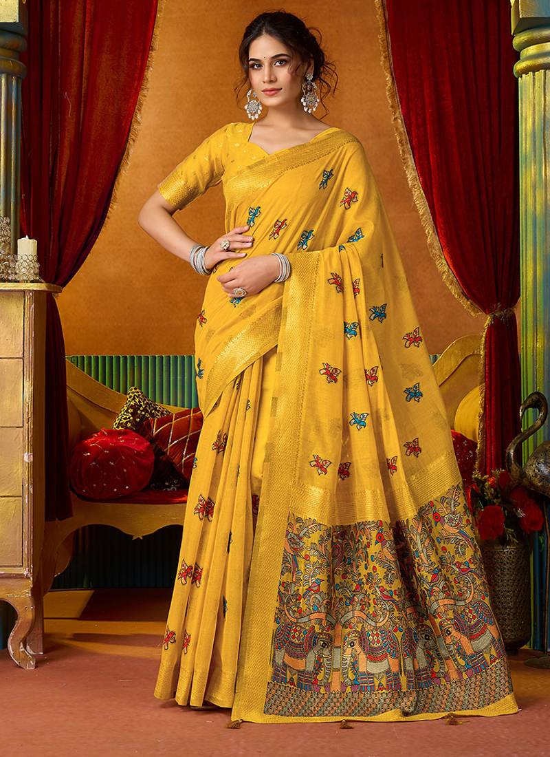 Mustard cotton blend saree with traditional ethnic motifs and includes blouse piece