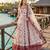 Red & white faux georgette suit with embroidery & tassels attached