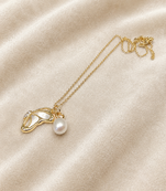 Gold-tone pearl pendant necklace with shell charm and crystal