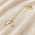 Gold-tone pearl pendant necklace with shell charm and crystal