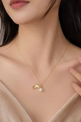 Gold-tone pearl pendant necklace with shell charm and crystal
