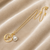 Gold-tone rose charm and freshwater pearl pendant necklace