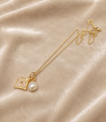 Gold-tone flower charm and pearl pendant necklace
