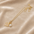Gold-tone flower charm and pearl pendant necklace