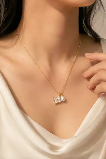Gold-tone flower charm and pearl pendant necklace