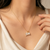Gold-tone flower charm and pearl pendant necklace
