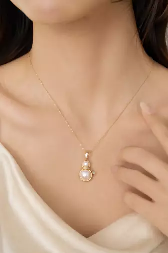 Double pearl pendant necklace with crystal charm, gold-tone