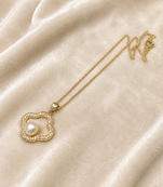 Gold-tone clover pearl pendant necklace with crystal accents
