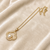 Gold-tone clover pearl pendant necklace with crystal accents