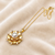 Gold-tone floral pearl pendant necklace with crystal accents
