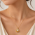 Gold-tone floral pearl pendant necklace with crystal accents