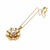 Gold-tone floral pearl pendant necklace with crystal accents