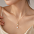Double pearl pendant necklace with gold-tone chain