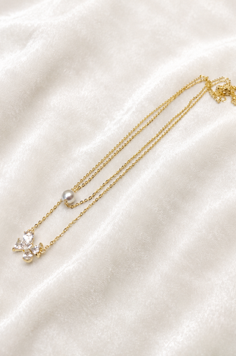 Layered gold chain necklace with pearl and crystal flower