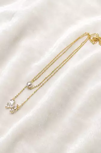 Layered gold chain necklace with pearl and crystal flower