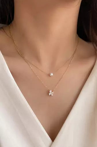 Layered gold chain necklace with pearl and crystal flower