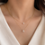 Layered gold chain necklace with pearl and crystal flower