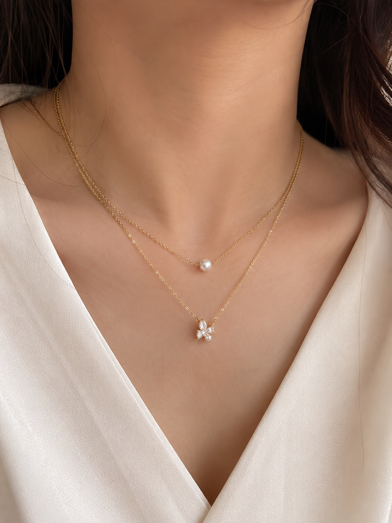 Layered gold chain necklace with pearl and crystal flower