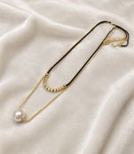 Layered pearl pendant necklace with black cord and gold chain