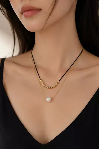 Layered pearl pendant necklace with black cord and gold chain