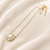 Pearl pendant necklace with crystal halo, gold-tone chain