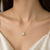 Pearl pendant necklace with crystal halo, gold-tone chain