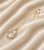 Baroque pearl pendant necklace with gold-tone leaf setting