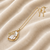 Baroque pearl pendant necklace with gold-tone leaf setting