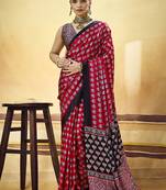 Red satin printed saree with orange border and unstiched blouse