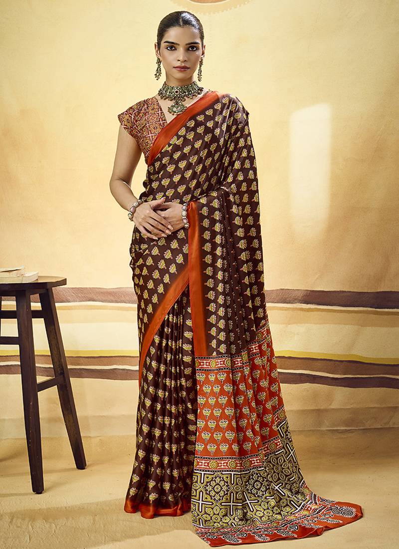 Brown satin printed saree with orange border and unstiched blouse