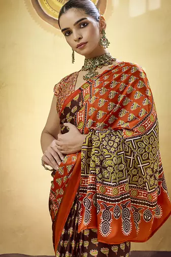 Brown satin printed saree with orange border and unstiched blouse