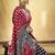 Black satin printed saree with orange border and unstiched blouse