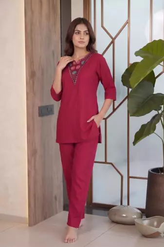 Women new rani pink solid kurta pant set with heavy neck embroidery